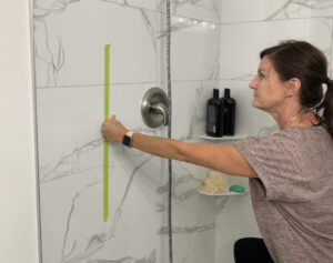 Marnie taping wall for grab bar placement